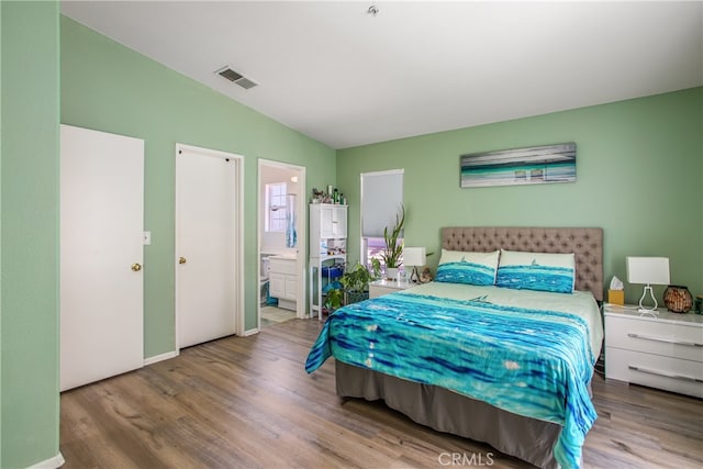 25545 Prospect Ave, Loma Linda, CA 92354 - bedroom featuring vaulted ceiling, wood finished floors, and ensuite bath
