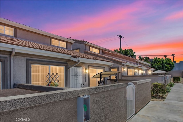 25545 Prospect Ave, Loma Linda, CA 92354 - mediterranean / spanish-style home featuring stucco siding, a tile roof, and a gate