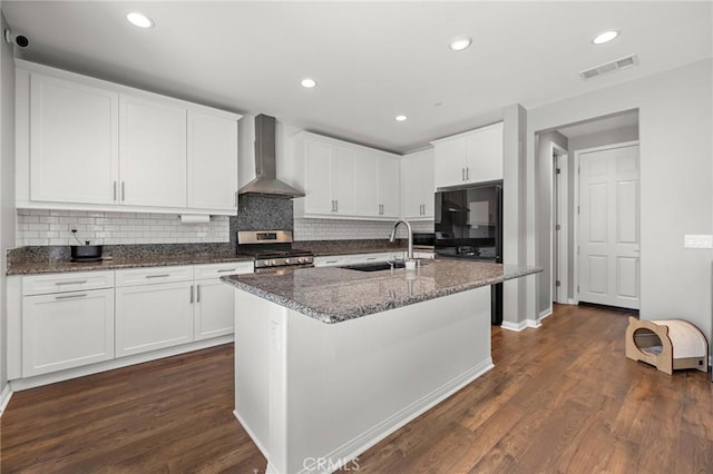 571 E Alru Ave, Rialto, CA 92376 - kitchen featuring wall chimney range hood, stainless steel range, dark wood-style flooring, tasteful backsplash, and recessed lighting