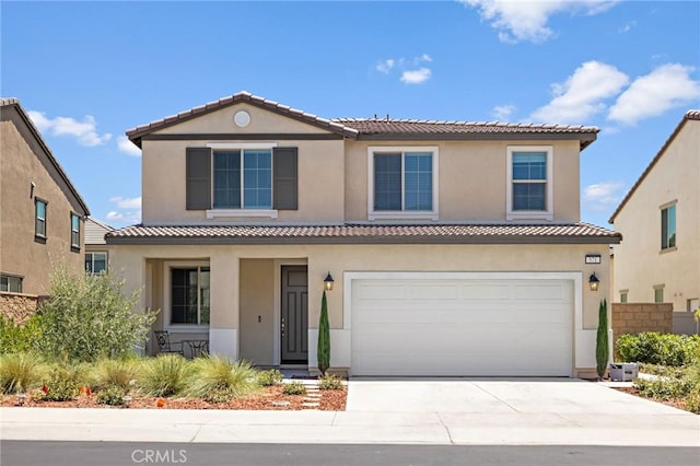 571 E Alru Ave, Rialto, CA 92376 - view of front of property featuring an attached garage, concrete driveway, a tiled roof, and stucco siding