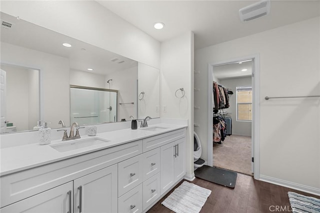 571 E Alru Ave, Rialto, CA 92376 - full bath featuring double vanity, a shower stall, wood finished floors, a walk in closet, and recessed lighting