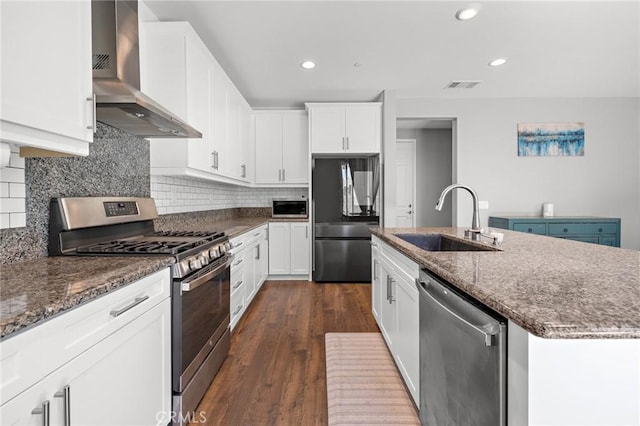 571 E Alru Ave, Rialto, CA 92376 - kitchen with appliances with stainless steel finishes, wall chimney range hood, an island with sink, dark stone countertops, and dark wood-style floors