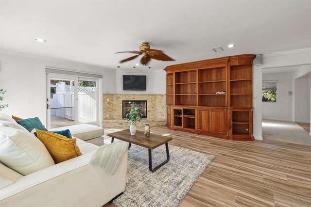 15696 Oakstand Rd, Poway, CA 92064 - living area featuring a ceiling fan, crown molding, recessed lighting, a glass covered fireplace, and light wood-style floors