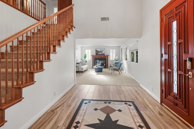15696 Oakstand Rd, Poway, CA 92064 - foyer with a towering ceiling, wood finished floors, stairs, and a glass covered fireplace