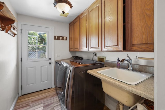 15696 Oakstand Rd, Poway, CA 92064 - washroom featuring washing machine and dryer, cabinet space, and light wood-style floors