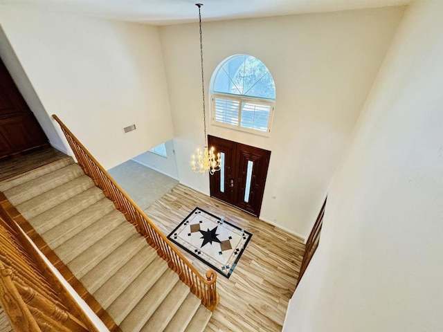 15696 Oakstand Rd, Poway, CA 92064 - foyer featuring high vaulted ceiling, wood finished floors, a chandelier, and stairs
