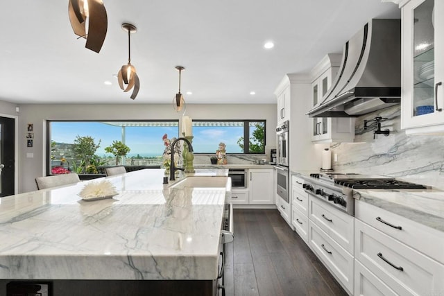 7133 Linden, Carlsbad, CA 92011 - kitchen with appliances with stainless steel finishes, plenty of natural light, premium range hood, recessed lighting, and a large island with sink