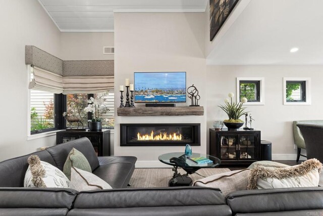 7133 Linden, Carlsbad, CA 92011 - living area featuring a glass covered fireplace and ornamental molding