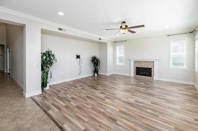 33740 Sattui St, Temecula, CA 92592 - unfurnished living room featuring a ceiling fan, ornamental molding, light wood-style flooring, recessed lighting, and a glass covered fireplace
