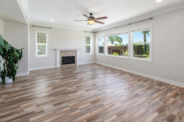 33740 Sattui St, Temecula, CA 92592 - unfurnished living room featuring healthy amount of natural light, wood finished floors, ceiling fan, ornamental molding, and a premium fireplace
