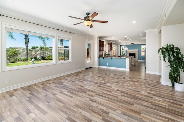 33740 Sattui St, Temecula, CA 92592 - unfurnished living room featuring recessed lighting, ornamental molding, ceiling fan, wood finished floors, and a fireplace