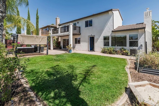 33740 Sattui St, Temecula, CA 92592 - back of property featuring a balcony, a jacuzzi, a yard, a patio area, and stucco siding
