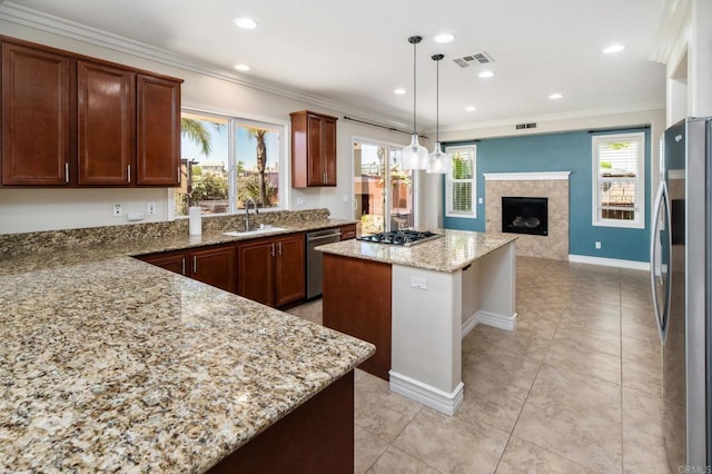 33740 Sattui St, Temecula, CA 92592 - kitchen with appliances with stainless steel finishes, a premium fireplace, a center island, light stone countertops, and open floor plan