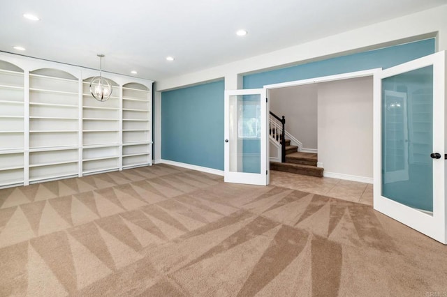 33740 Sattui St, Temecula, CA 92592 - carpeted empty room with french doors, recessed lighting, stairway, a chandelier, and built in shelves