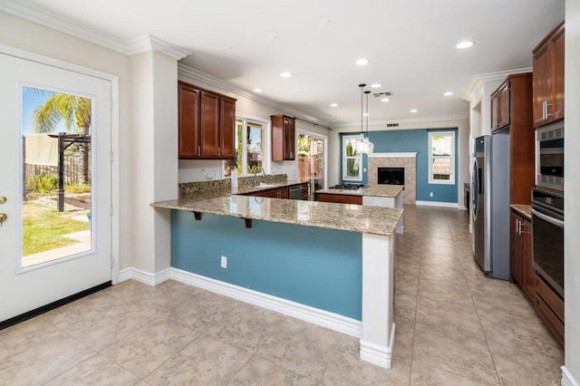 33740 Sattui St, Temecula, CA 92592 - kitchen with a peninsula, stainless steel appliances, light stone countertops, crown molding, and recessed lighting