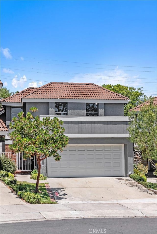 34 Carmel Ct, Laguna Beach, CA 92651 - view of front of home with concrete driveway, stucco siding, and a tiled roof