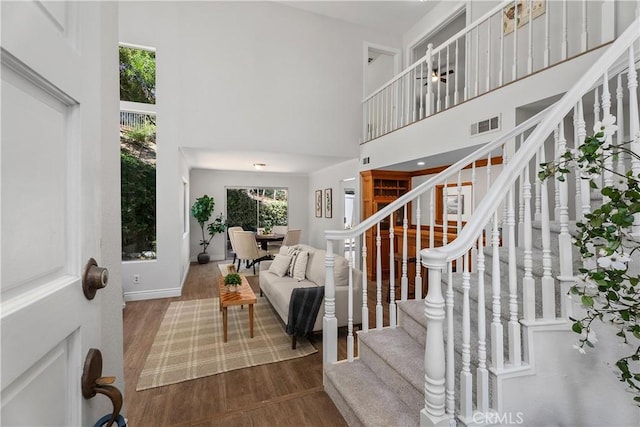 34 Carmel Ct, Laguna Beach, CA 92651 - entrance foyer featuring a towering ceiling, wood finished floors, and stairway