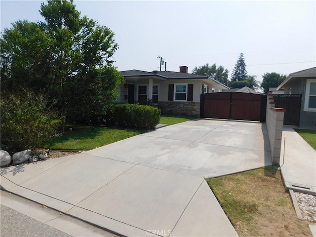 620 N La Sena Ave, West Covina, CA 91790 - view of front of property featuring a gate, stone siding, driveway, a front yard, and stucco siding