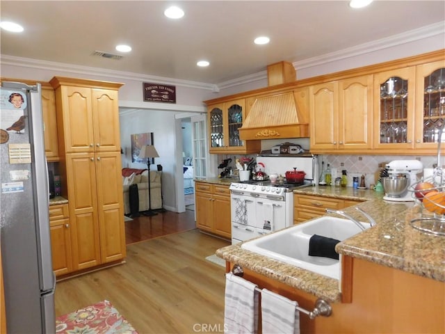 620 N La Sena Ave, West Covina, CA 91790 - kitchen featuring freestanding refrigerator, double oven range, custom exhaust hood, ornamental molding, and light wood-style flooring