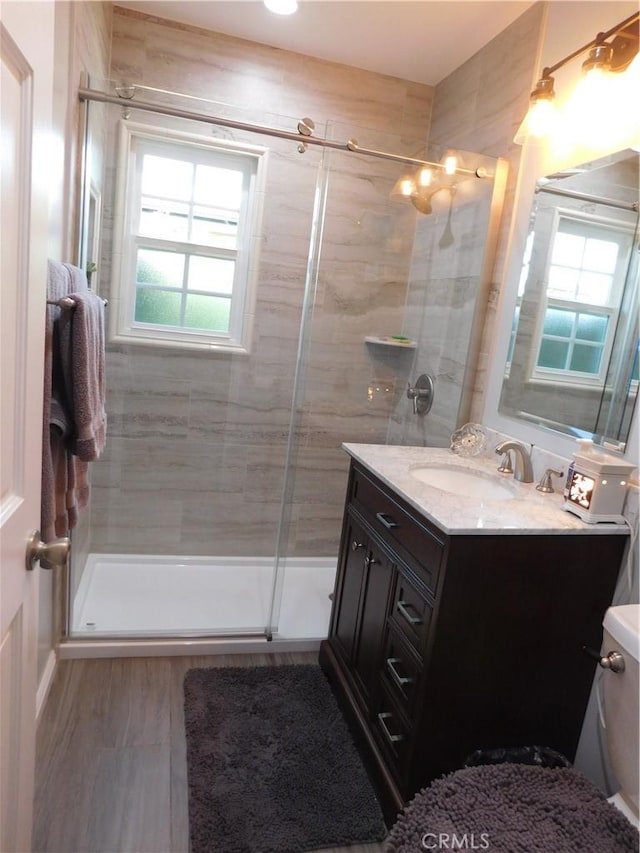 620 N La Sena Ave, West Covina, CA 91790 - bathroom with vanity, a shower stall, and wood finished floors