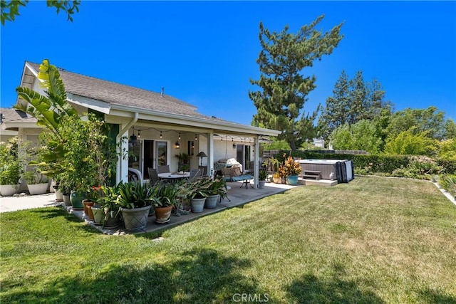 42244 Cosmic Dr, Temecula, CA 92592 - back of property featuring a hot tub, a patio, and a lawn