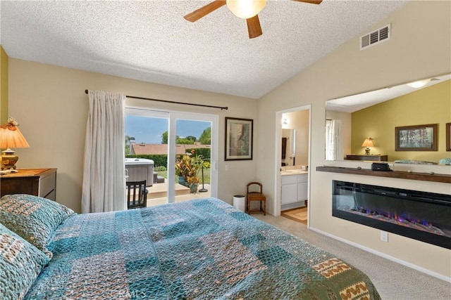 42244 Cosmic Dr, Temecula, CA 92592 - carpeted bedroom featuring access to exterior, vaulted ceiling, a textured ceiling, ensuite bathroom, and ceiling fan