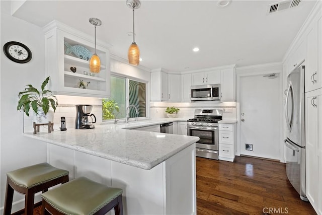42244 Cosmic Dr, Temecula, CA 92592 - kitchen with appliances with stainless steel finishes, a peninsula, tasteful backsplash, white cabinets, and recessed lighting