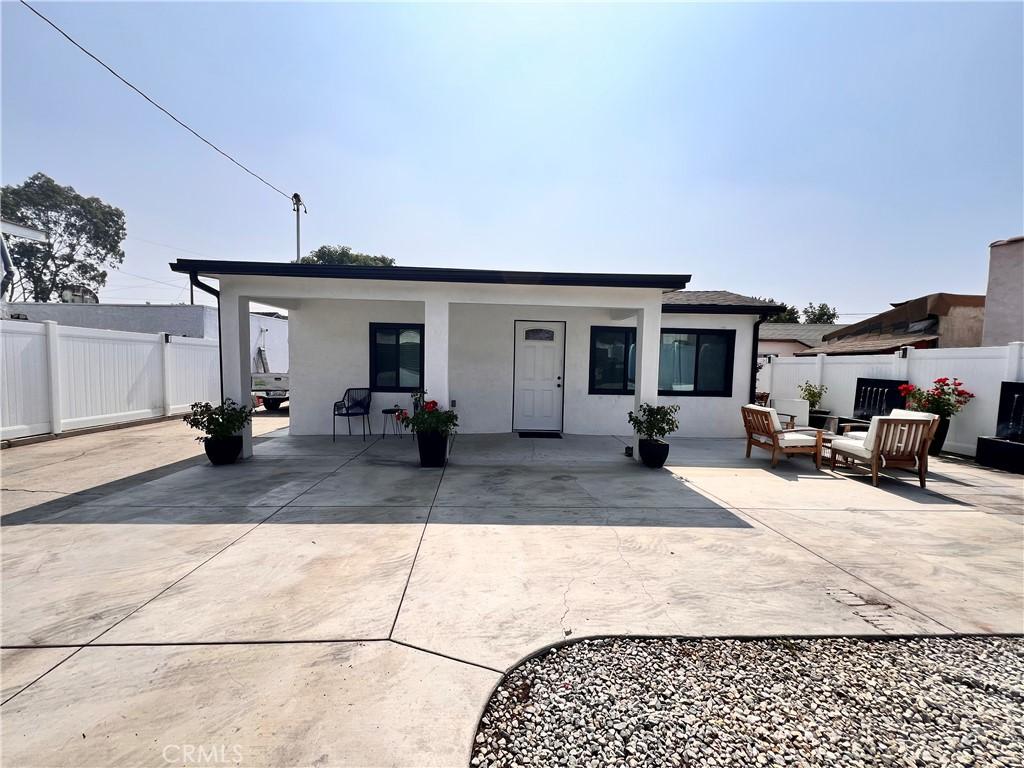 326 S Mcbride Ave, Los Angeles, CA 90022 - rear view of house featuring a patio, stucco siding, and outdoor lounge area