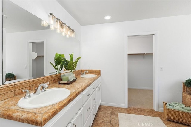 21285 Shoemaker Ln, Wildomar, CA 92595 - bathroom featuring double vanity, tile patterned floors, a spacious closet, and recessed lighting