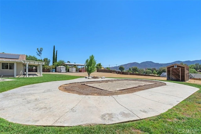 21285 Shoemaker Ln, Wildomar, CA 92595 - view of grassy yard featuring a storage unit, a mountain view, and a patio