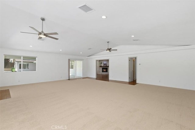 21285 Shoemaker Ln, Wildomar, CA 92595 - unfurnished living room featuring ceiling fan, carpet, vaulted ceiling, a lit fireplace, and recessed lighting