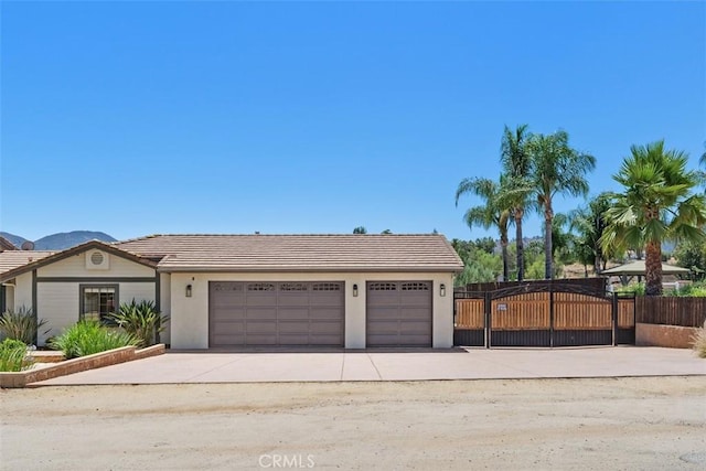 21285 Shoemaker Ln, Wildomar, CA 92595 - view of front of home with concrete driveway, a garage, a tiled roof, and stucco siding