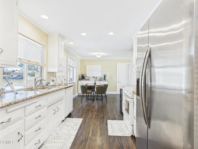 2025 N Chouteau St, Orange, CA 92865 - kitchen with white appliances, dark wood finished floors, white cabinets, crown molding, and light stone counters