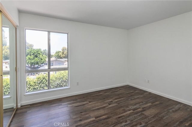 16755 Parthenia St Unit 5, Northridge, CA 91343 - spare room with healthy amount of natural light and dark wood-type flooring