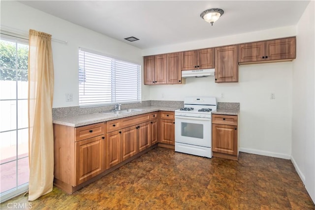 16755 Parthenia St Unit 5, Northridge, CA 91343 - kitchen with gas range gas stove, under cabinet range hood, brown cabinets, and light countertops