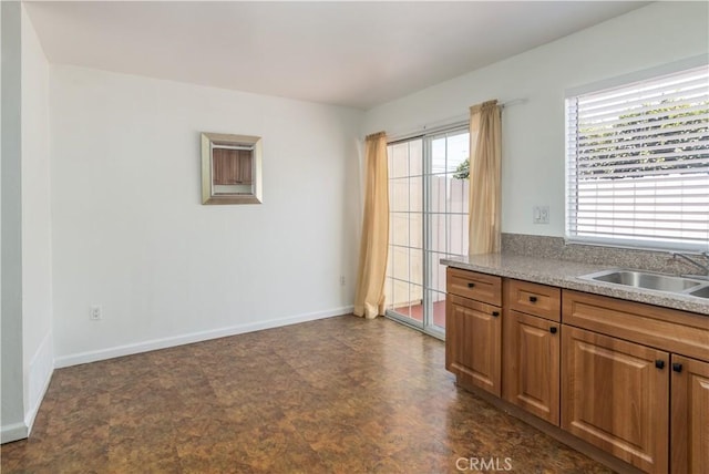 16755 Parthenia St Unit 5, Northridge, CA 91343 - kitchen with brown cabinetry and light countertops