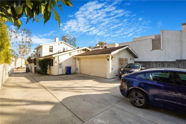 1129 Walnut Grove Ave, Rosemead, CA 91770 - view of home's exterior with stucco siding, a garage, and driveway
