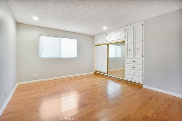 1129 Walnut Grove Ave, Rosemead, CA 91770 - unfurnished bedroom with a textured ceiling, light wood-style flooring, recessed lighting, and a closet