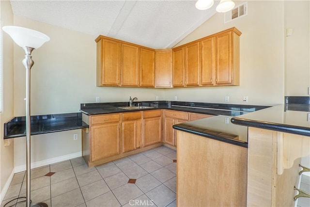 1129 Walnut Grove Ave, Rosemead, CA 91770 - kitchen featuring vaulted ceiling, a textured ceiling, a peninsula, light tile patterned flooring, and dark countertops
