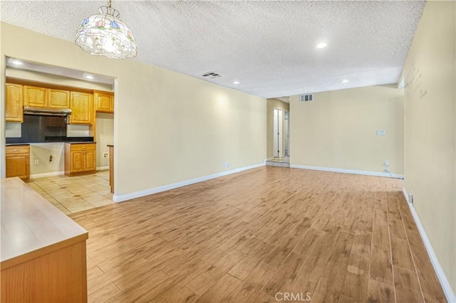 1129 Walnut Grove Ave, Rosemead, CA 91770 - unfurnished living room featuring a textured ceiling, light wood finished floors, recessed lighting, and a chandelier