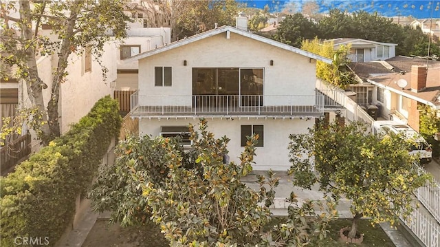 1129 Walnut Grove Ave, Rosemead, CA 91770 - rear view of property with a balcony and stucco siding
