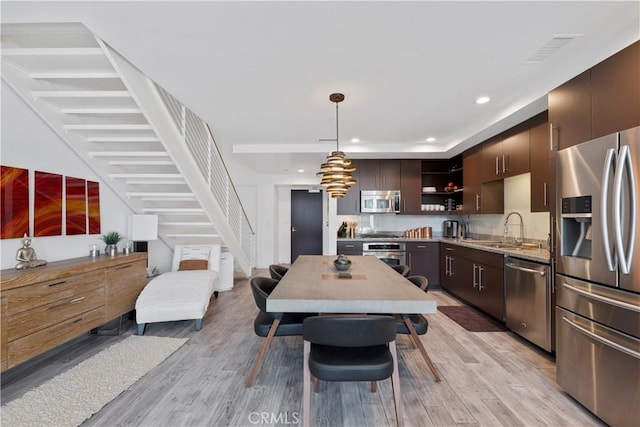 1100 Wilshire Blvd Unit 1707, Los Angeles, CA 90017 - dining area featuring light wood finished floors, stairs, and recessed lighting