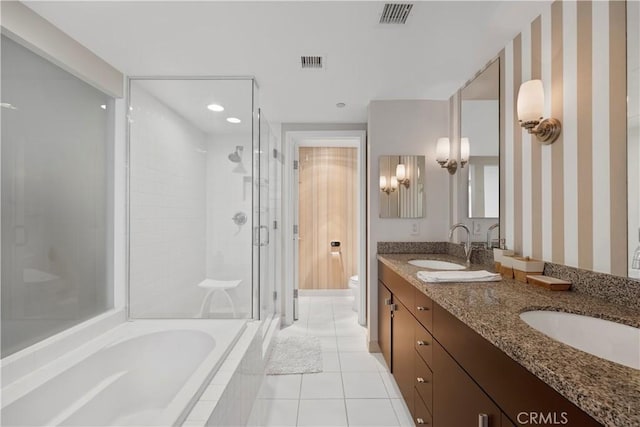 1100 Wilshire Blvd Unit 1707, Los Angeles, CA 90017 - bathroom featuring a stall shower, wallpapered walls, double vanity, tile patterned floors, and a garden tub