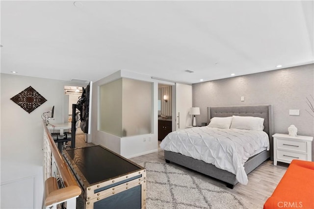 1100 Wilshire Blvd Unit 1707, Los Angeles, CA 90017 - bedroom featuring light wood-style floors, recessed lighting, a spacious closet, and ensuite bathroom
