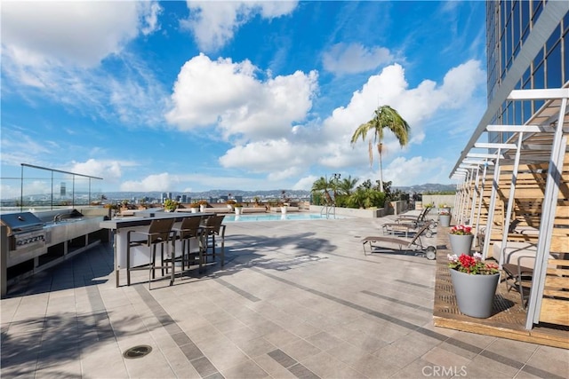 1100 Wilshire Blvd Unit 1707, Los Angeles, CA 90017 - view of patio / terrace featuring a community pool, a bar, and stairway