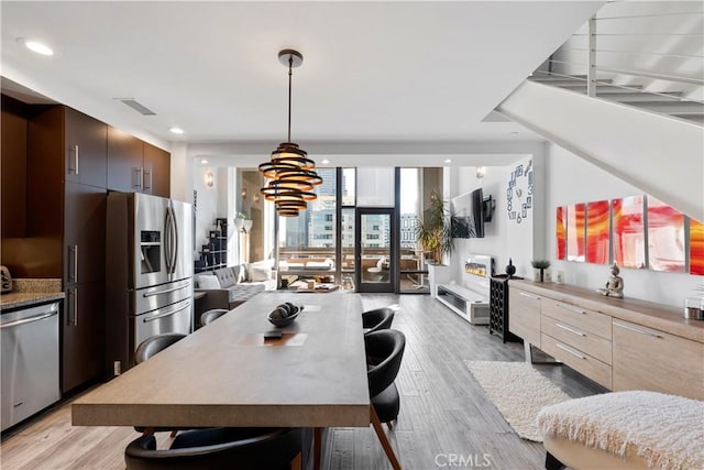 1100 Wilshire Blvd Unit 1707, Los Angeles, CA 90017 - dining area featuring light wood-style floors and recessed lighting