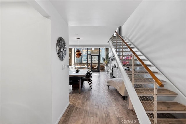 1100 Wilshire Blvd Unit 1707, Los Angeles, CA 90017 - stairway featuring wood finished floors and a wall of windows