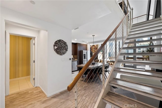 1100 Wilshire Blvd Unit 1707, Los Angeles, CA 90017 - staircase featuring wood finished floors and recessed lighting