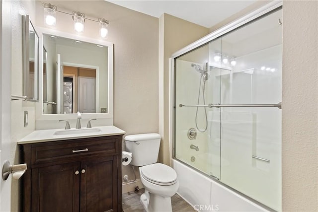1710 S El Camino Real Unit E204, Encinitas, CA 92024 - bathroom featuring vanity, shower / bath combination with glass door, and wood finished floors