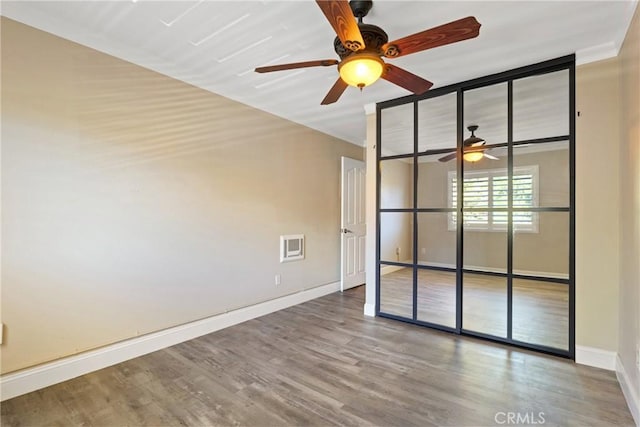 1710 S El Camino Real Unit E204, Encinitas, CA 92024 - empty room with a ceiling fan and wood finished floors